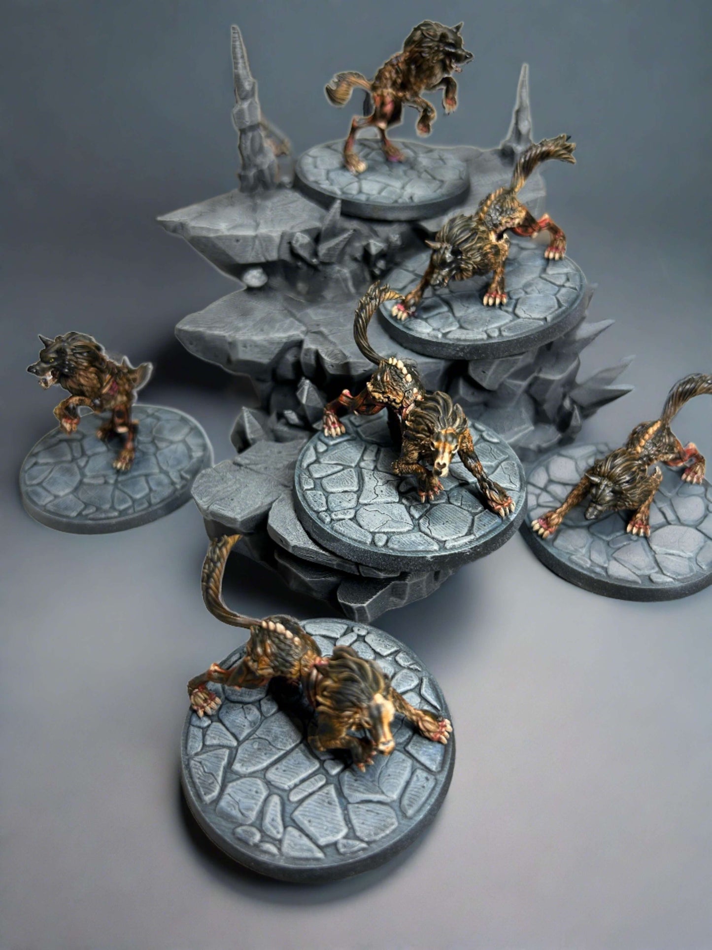 A group of six Midnight Wolf D&D miniatures. Arranged on a piece of rocky terrain. Painted to resemble blighted wolves, used in the UK D&D actual play series, Natural Six.